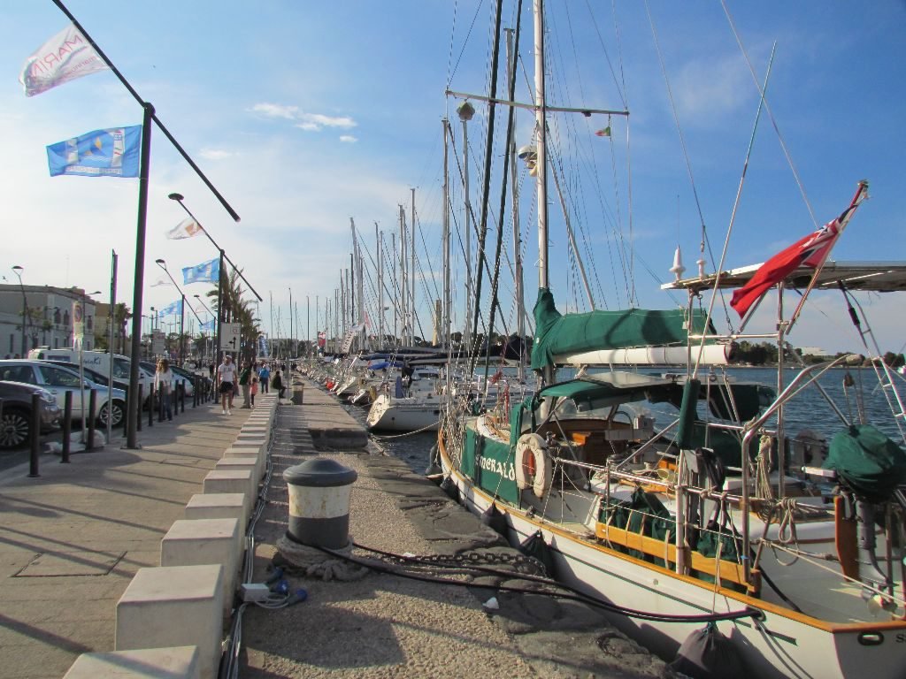 Emerald squeezed on the end of Brindisi town quay with a forest of race boats beyond