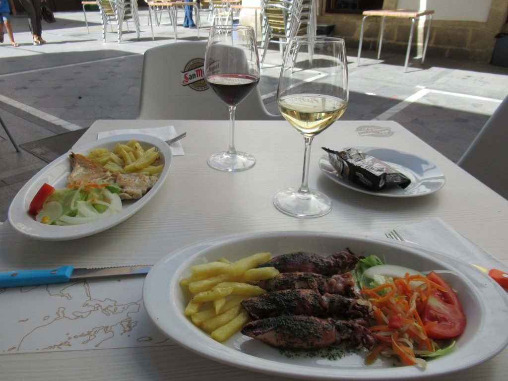 Lunch of fried squid and a glass of white wine